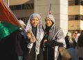 Zwei Frauen mit palästinensischer Flagge. Foto: unsplash/tristan-sosteric