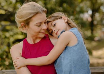 Mutter mit Kind im Arm im Park. (Foto: Unsplash)